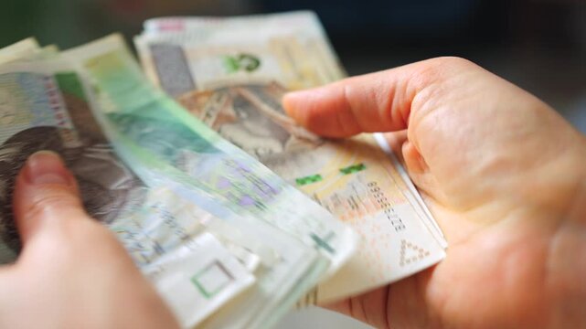 Female hands carefully counting polish zloty banknotes