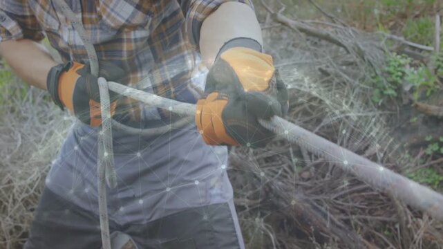 Forming loop with left hand, worker pulling speckled rope and tightening knot to secure brush