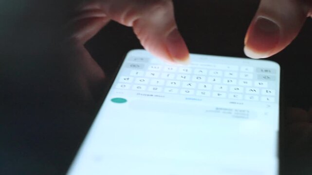 Female hands typing text on smartphone close-up.