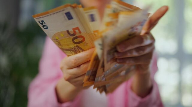 Woman counting euro bills, close-up