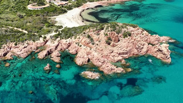 Aerial view of Su Sirboni Beach, Marina di Gairo, Sardinia, Italy. Turquoise sea, rugged red cliffs and hidden coves along the wild Ogliastra coastline