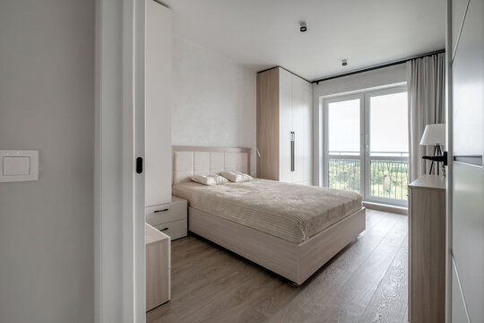 Interior of modern luxure bedroom in studio apartments or hotel with double master bed