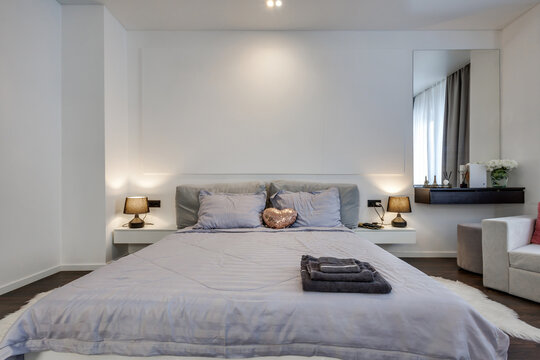 Interior of modern luxure bedroom in studio apartments or hotel with double master bed