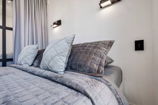 Interior of modern luxure bedroom in studio apartments or hotel with double master bed