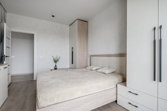 Interior of modern luxure bedroom in studio apartments or hotel with double master bed