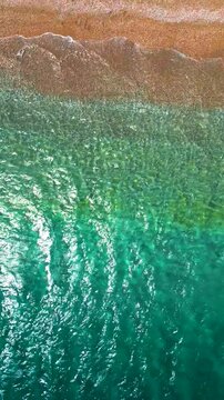 Top-down view of paradise pebble beach and crystal clear water. Rhodes, Greece