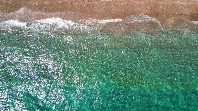 Top-down view of paradise pebble beach and crystal clear water. Rhodes, Greece