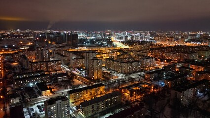 Naklejka premium Night Cityscape with Illuminated Residential District