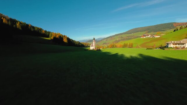 FPV Aerial view of the Church of St. Johann in Ranui at South Tyrol, Italy. 