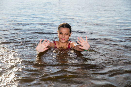 Children swim in a freshwater lake in hot weather