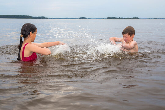 Children swim in a freshwater lake in hot weather