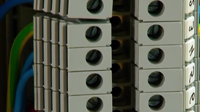 Detailed view showing the complex network of terminal blocks and diverse wiring inside an industrial electrical cabinet.
