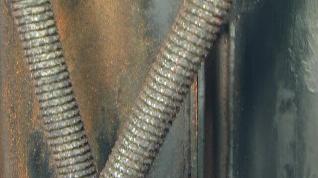 Detailed perspective of aged industrial air filter system. Corroded metal and grimy tubes illustrate years of heavy operation within robust engine compartment, highlighting mechanical resilience time.