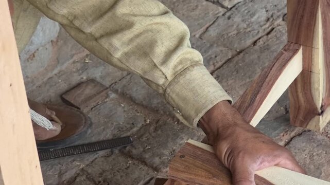 Woodworker's hands carefully assembling wooden joints for furniture in a rustic workshop with natural light High Quality Footage