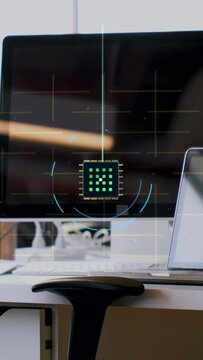Vertical video: Monitor powering on, HUD microchip UI appearing over desk, showing network links