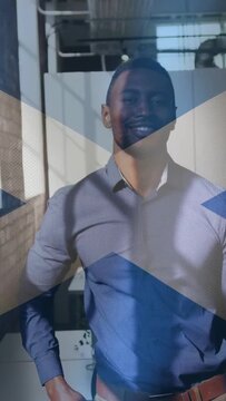 Vertical video: Man adjusting and smiling in office as frames playing blue X crossing torso