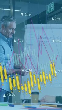 Vertical video: Man leading at chart drawing funnel and bars causing data overlays showing CRM data