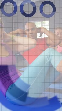 Vertical video: Fitness group doing crunches on mats, camera panning and overlay logging chart data