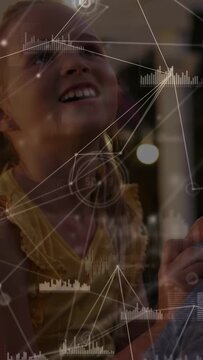 Vertical video: Girl reaching to receive toy offered by adult, AR overlay superimposing nodes bars