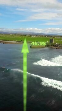 Vertical video: Drone panning, arrows rising, boarder paddling for wave as arrows showing data