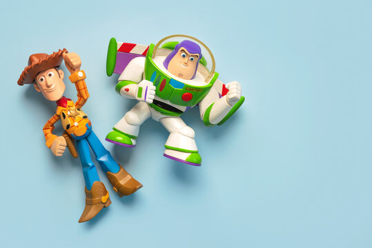 Woody and Buzz Lightyear action figures characters from the Toy Story movie Disney Pixar saga and space for text. Illustrative editorial