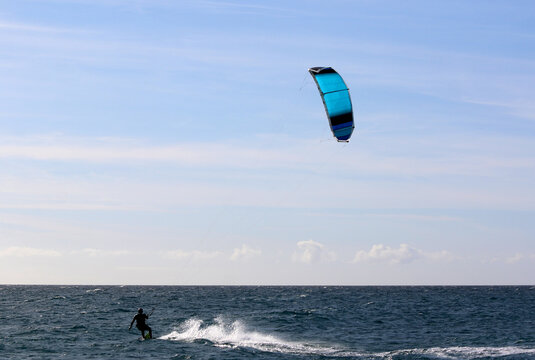 kitesurfer riding his board on the sea	