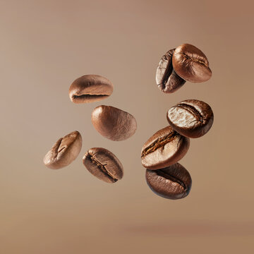 Flying roasted coffee beans isolated on beige background. Levitating aromatic arabica grains. Minimalist caffeine energy concept for espresso advertising.