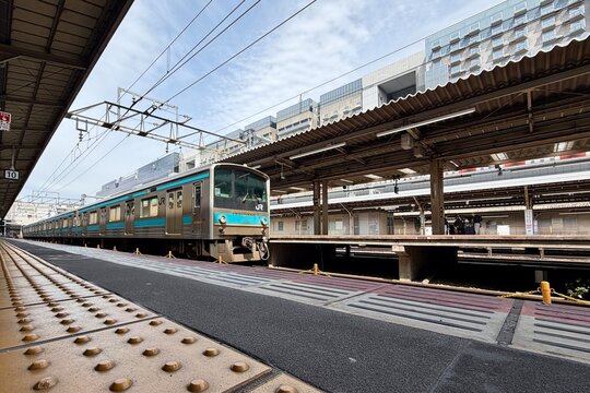 Kyoto, Japan - April 10, 2026: Train entering the platform at Kyoto Station, Japan Railways, modern metro and rail infrastructure with dynamic urban travel atmosphere.