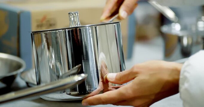 Woman Selects Cookware in Shopping Center Kitchen Aisle