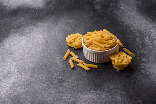 Italian uncooked dry penne regate pasta ready for cooking. Dry penne pasta