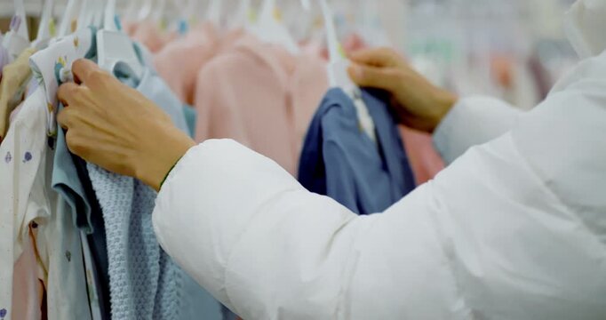 Woman Shopping for Baby Clothes in Shopping Mall