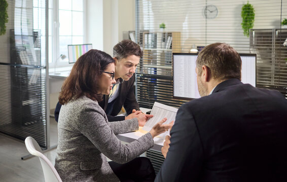 Colleagues managers meeting in office review data. They examine finance planning and report on monitor, compare figures, and align a business analysis for next choices. Data and team win big.