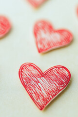 Fototapeta premium A arrangement of bright red hearts on a table vertical frame