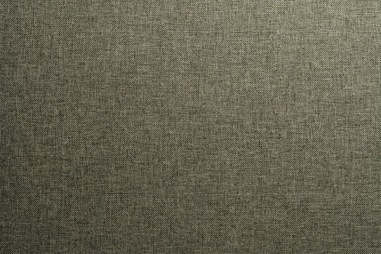 Detailed macro shot of woven grey olive fabric texture. Ideal for upholstery background interior design and fashion industry concepts