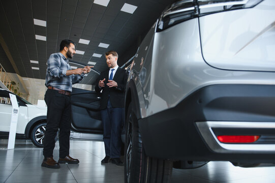 Car consultant talking with customer buying electric vehicle