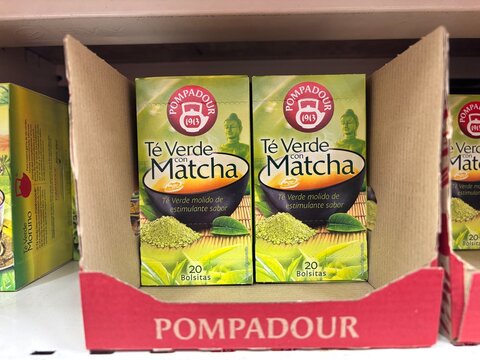 Alicante, Spain - April 25, 2026: Green tea with matcha boxes displayed on a shelf in a grocery store, Pompadour brand packaging visible in the foreground