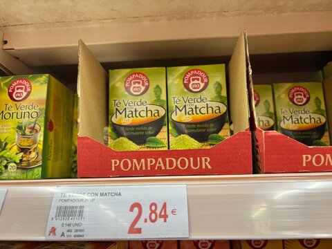 Alicante, Spain - April 25, 2026: Pompadour green matcha tea boxes displayed on a supermarket shelf with price tag visible in a retail environment
