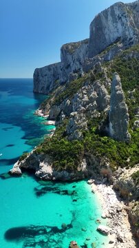 Aerial view of Cala Goloritz&egrave;, Baunei Coast, Sardinia, Italy. Iconic turquoise waters, white limestone cliffs adn pristine beach, often ranked among the most beautiful beaches in the world