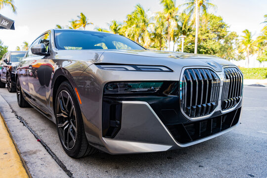 Miami, Florida, USA - July 27, 2025: Grey electric saloon car, low view. BMW i7 G70 generation 2023 sedan or saloon electric car. Luxury electric sedan car BMW i7 G70. Car BMW i7 G70 parked outdoor