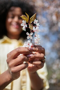 Young woman fresh flowers enjoying springtime and nature