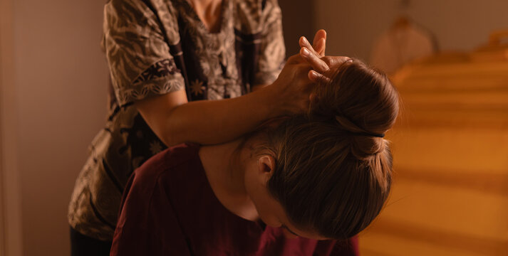 Asian female adult receiving relaxing thai massage therapy in spa setting
