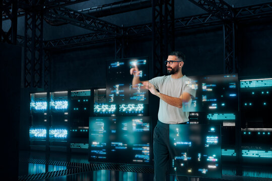 Software developer interacting with holographic code panels in 3D server room