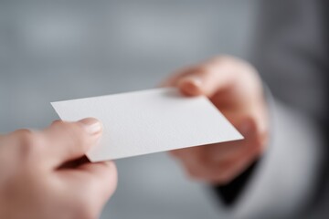 Obraz premium Business card exchange between two young professionals, startup networking concept