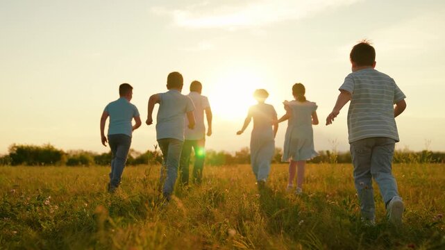 Active family run green grass. Child mom dad play together outdoors. Family running on lawn. Mom dad son daughter family weekend nature. Happy children parents play in park. Kids dad mom. happy people