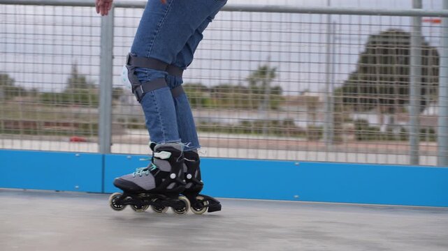 Inline skates close up rolling legs with knee pads outdoor