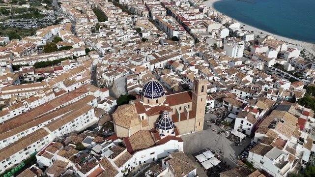 Aerial drone view of Altea old town with blue domed church white houses and Mediterranean coastline in Spain