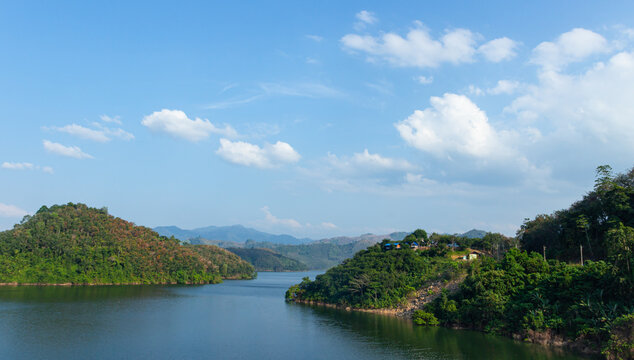 Beautiful panoramic landscape of Bang Lang Dam reservoir with lush green mountains and blue sky at Mae Wat Yala Thailand