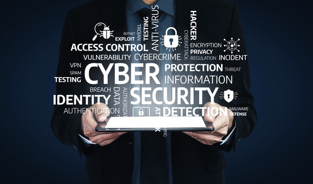 A professional figure holds a tablet featuring various cybersecurity terms, illustrating the importance of digital protection and defense in today technology landscape. Tessel
