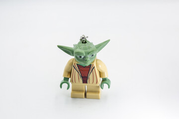 Naklejka premium Yoda toy figure from Star Wars film closeup on white.
