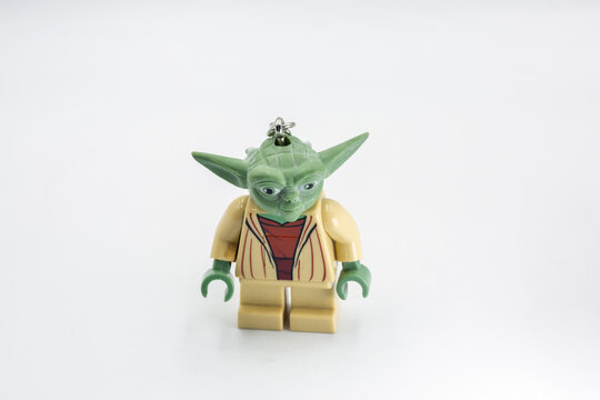 Yoda toy figure from Star Wars film closeup on white.
